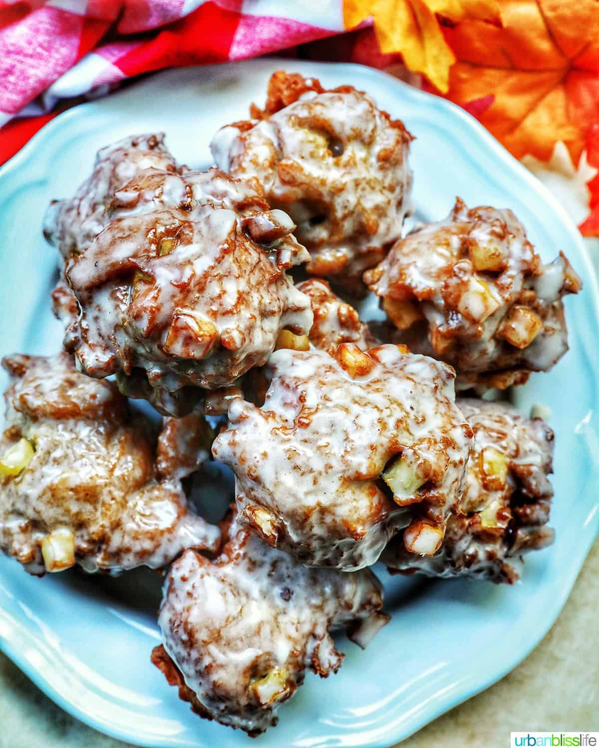 apple fritter donuts stacked on top of each other on a plate.