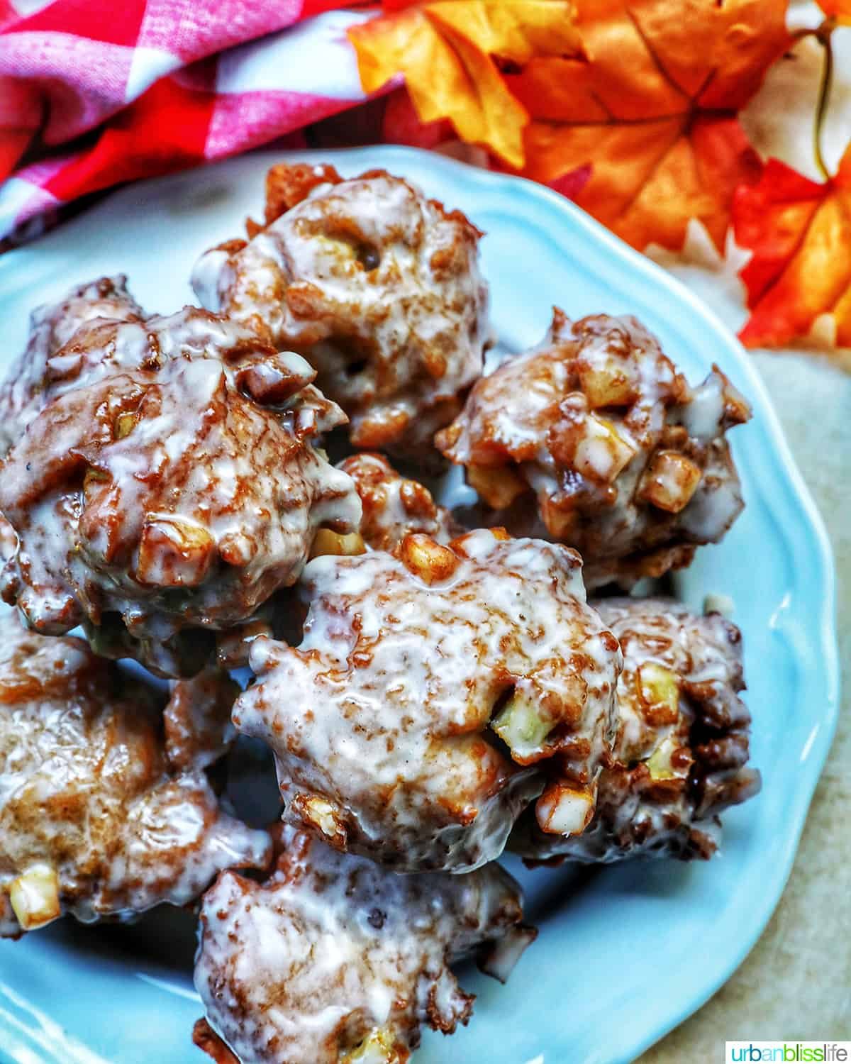 apple fritter donuts stacked on top of each other on a plate