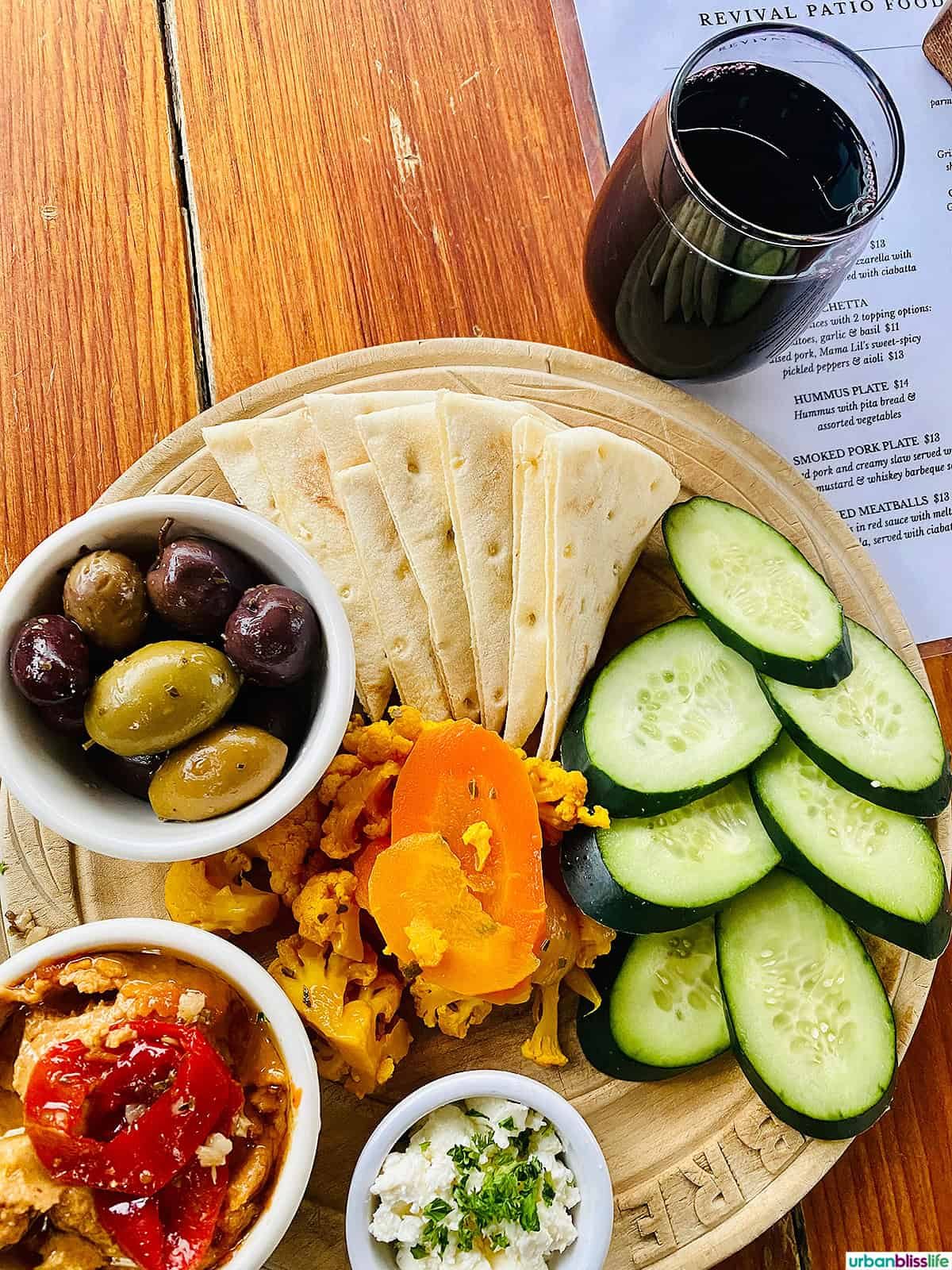 snack plate and glass of red wine at Bible Club PDX.