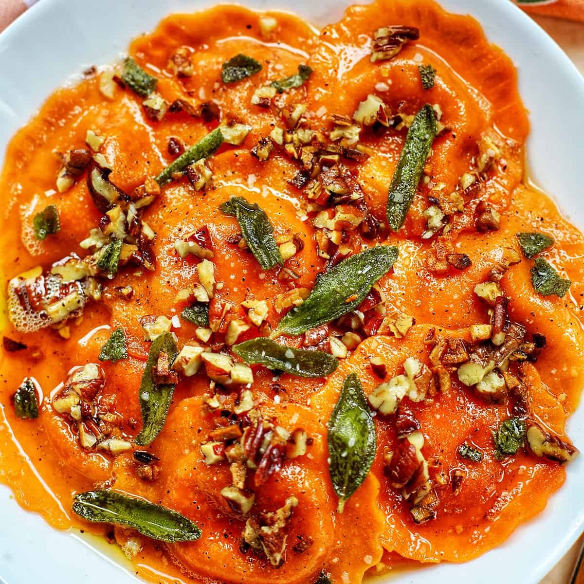 butternut squash ravioli with brown butter sage sauce and herbs.