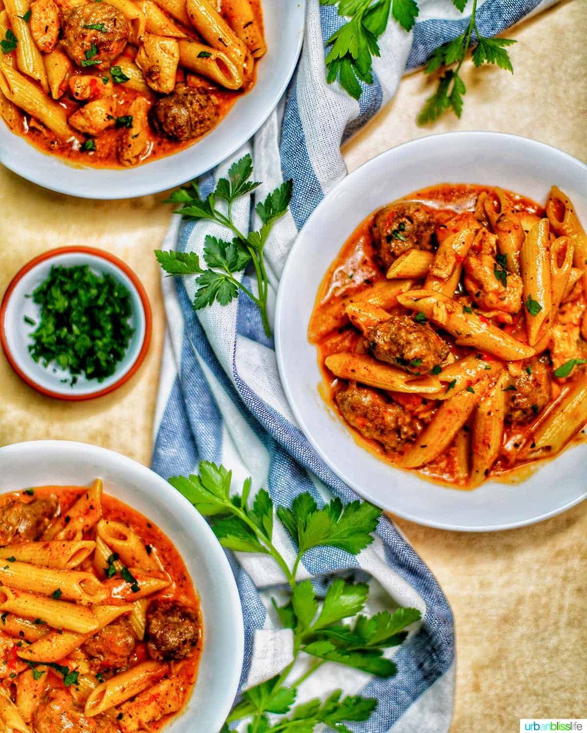 bowls of Pressure-cooker Cajun Chicken Pasta with greenery