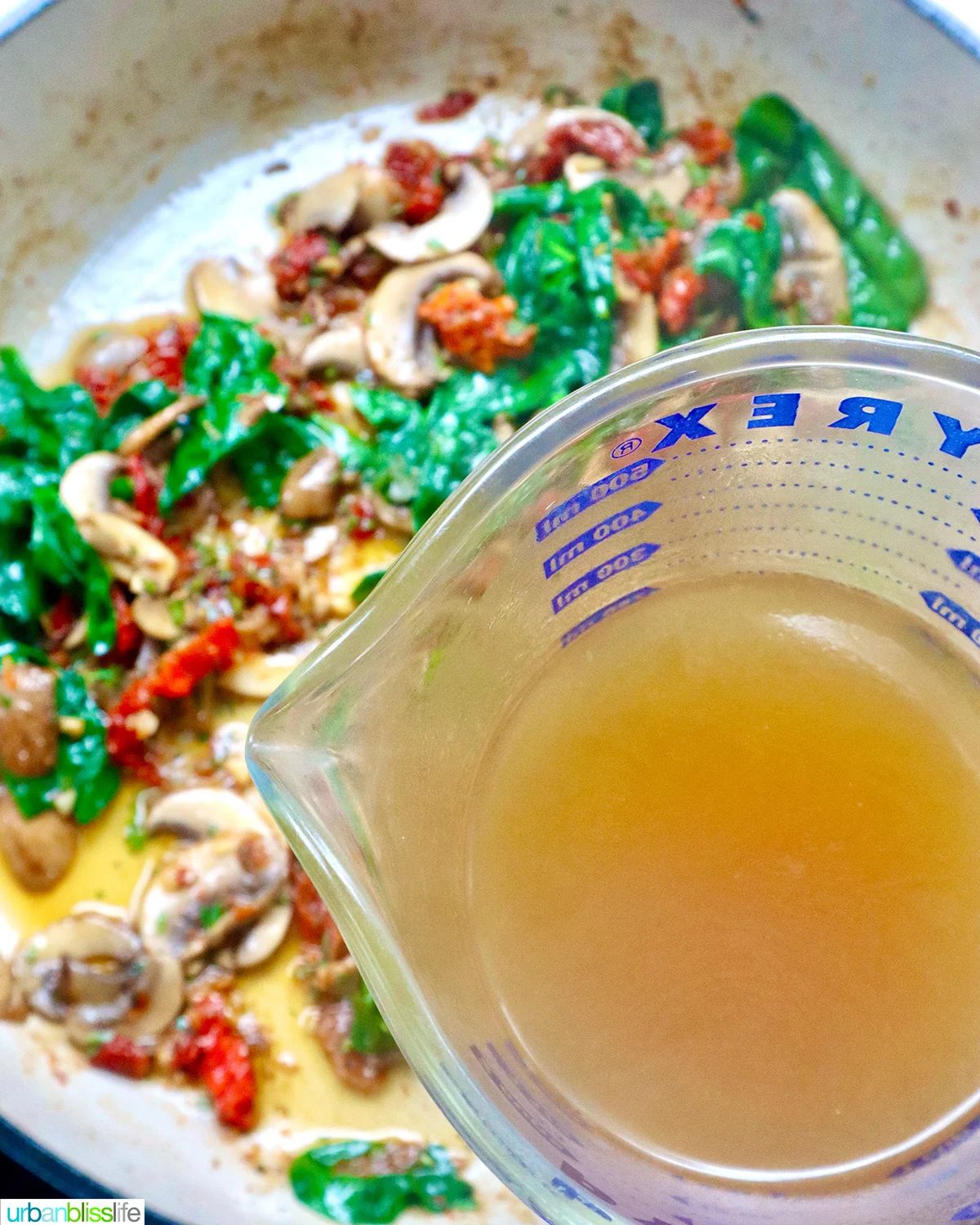 adding chicken broth into sundried tomatoes, mushrooms, spinach.