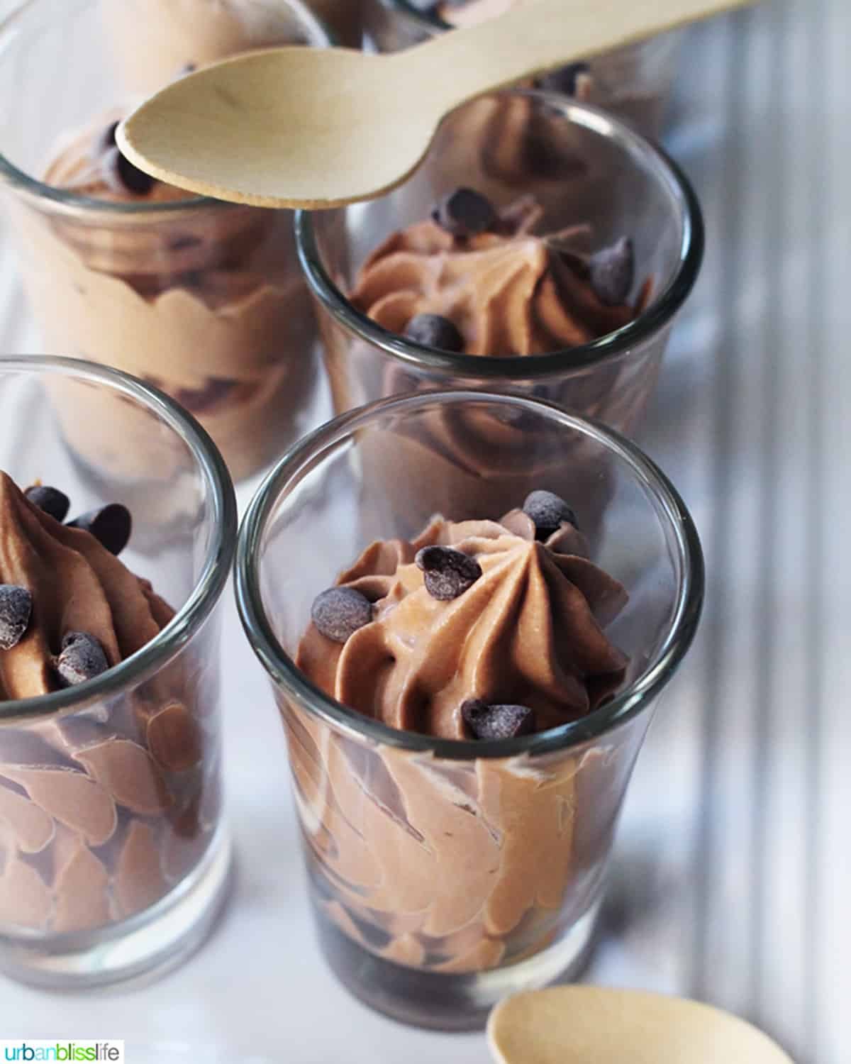 dairy free chocolate mousse in shot glasses with wooden spoons