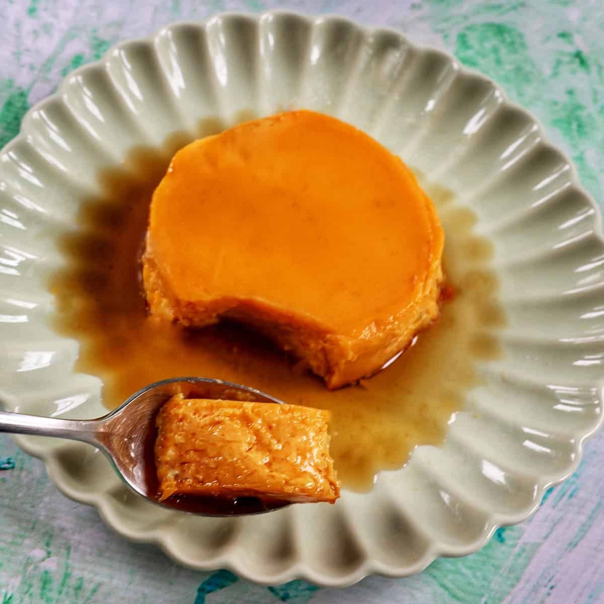 spoonful of filipino leche flan with caramel sauce