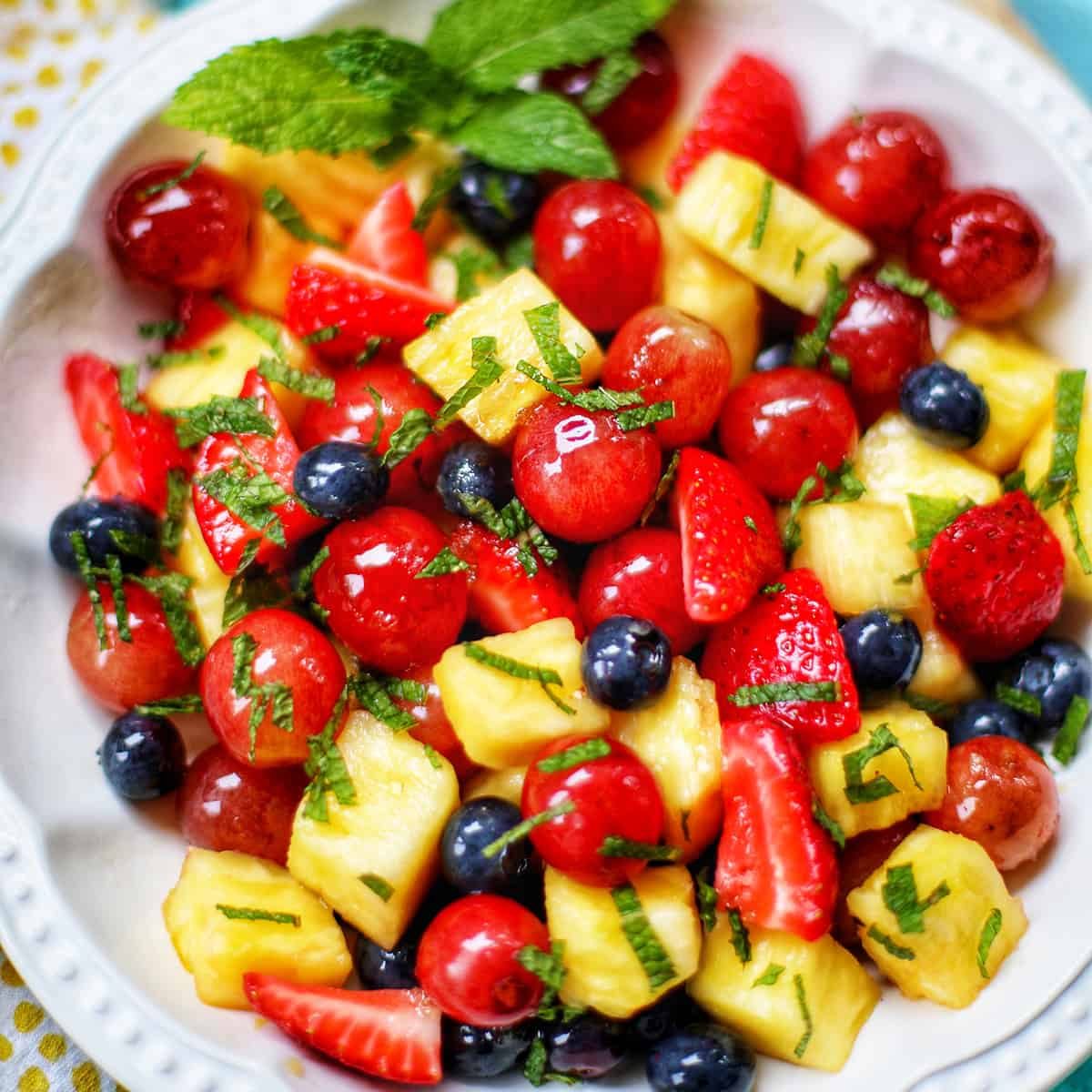 simple fruit salad with strawberries, blueberries, grapes, and pineapple.