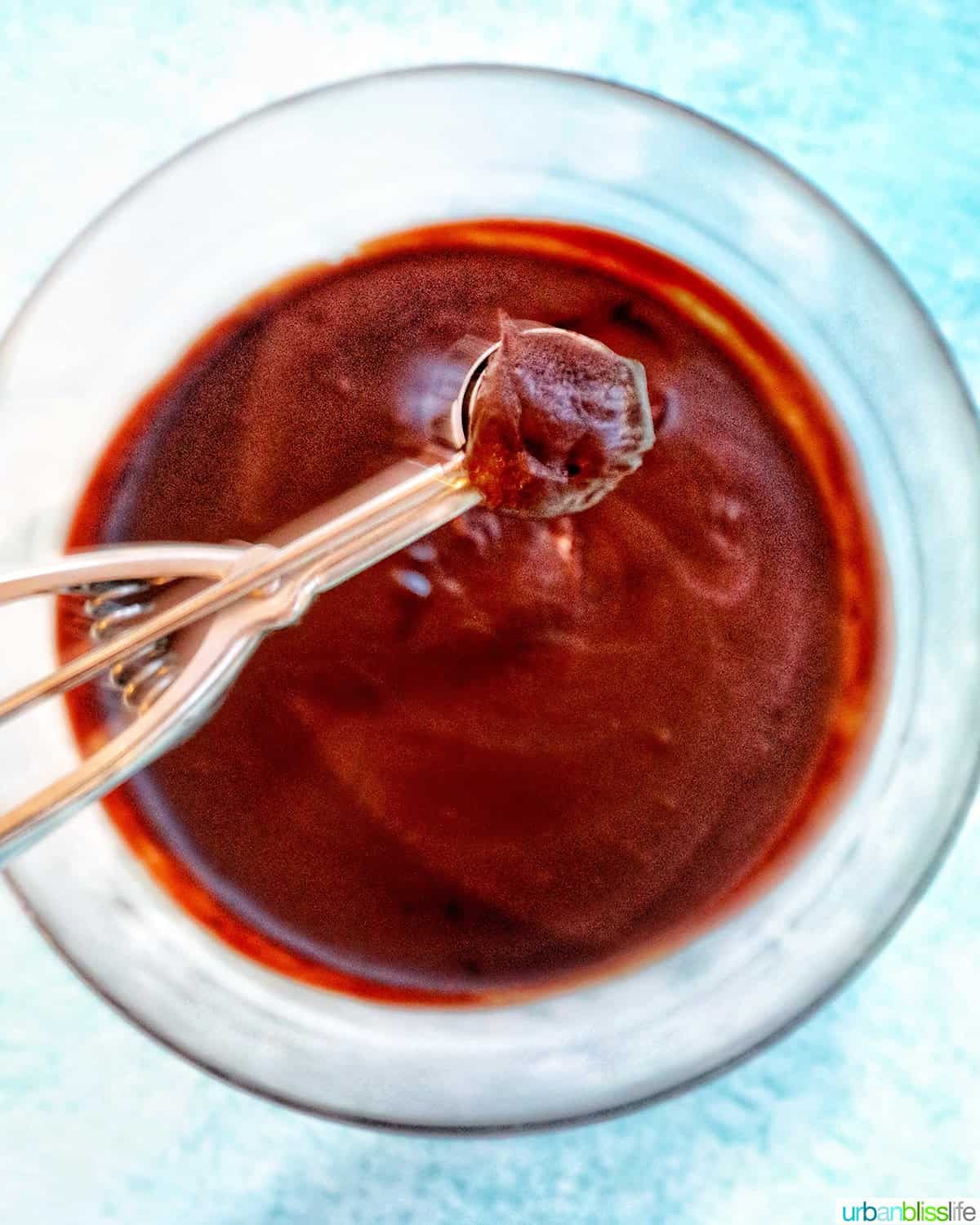 scoopng honey bourbon truffle dough from bowl.