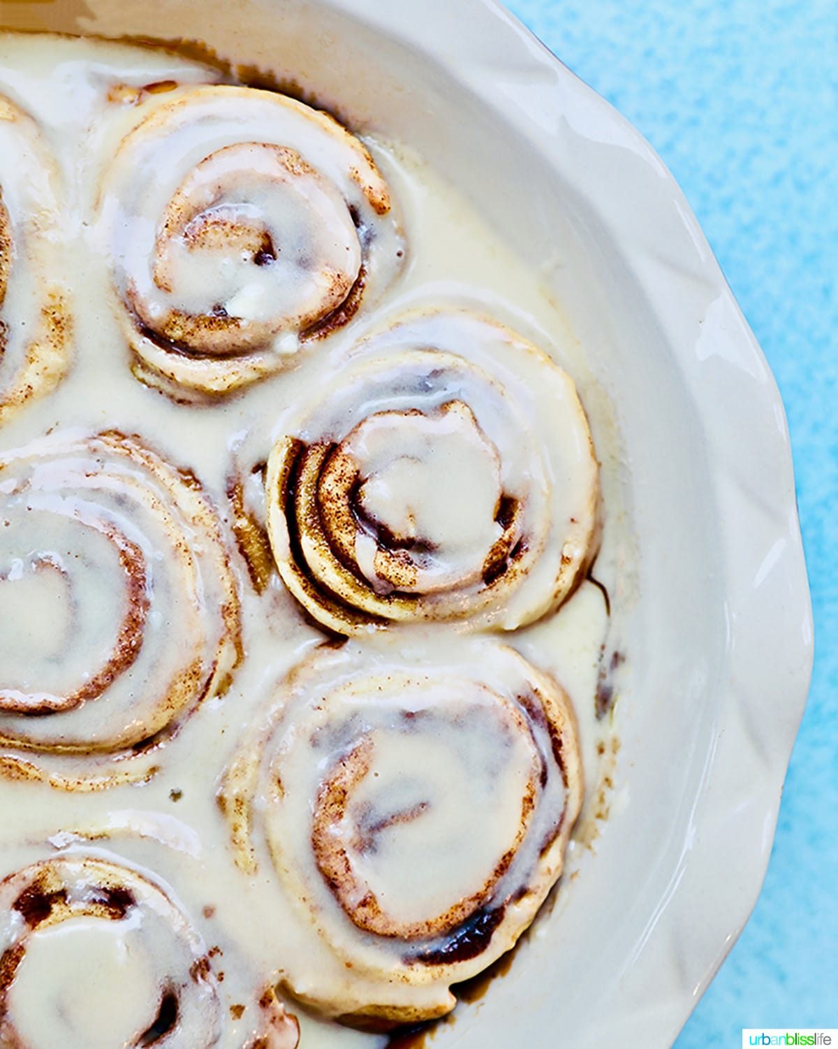 half pan of orange cinnamon rolls with icing