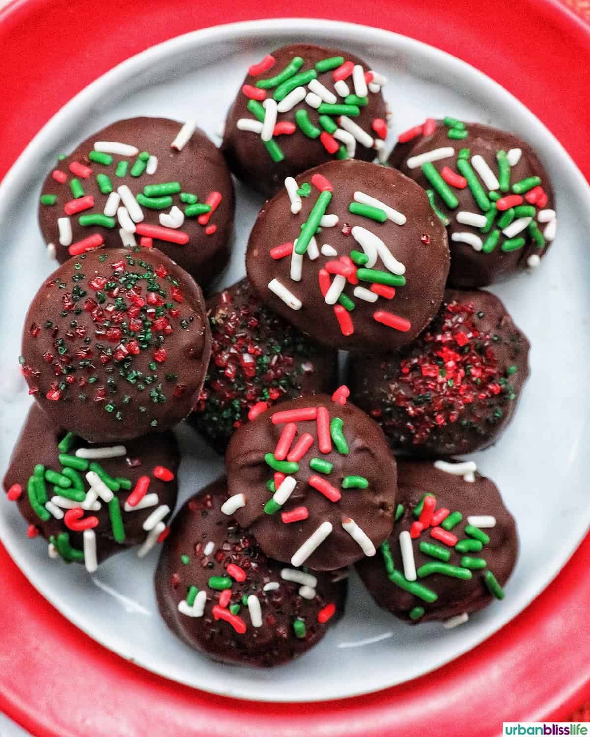 oreo truffles with red, white, and green sprinkles in a Christmas table setting.