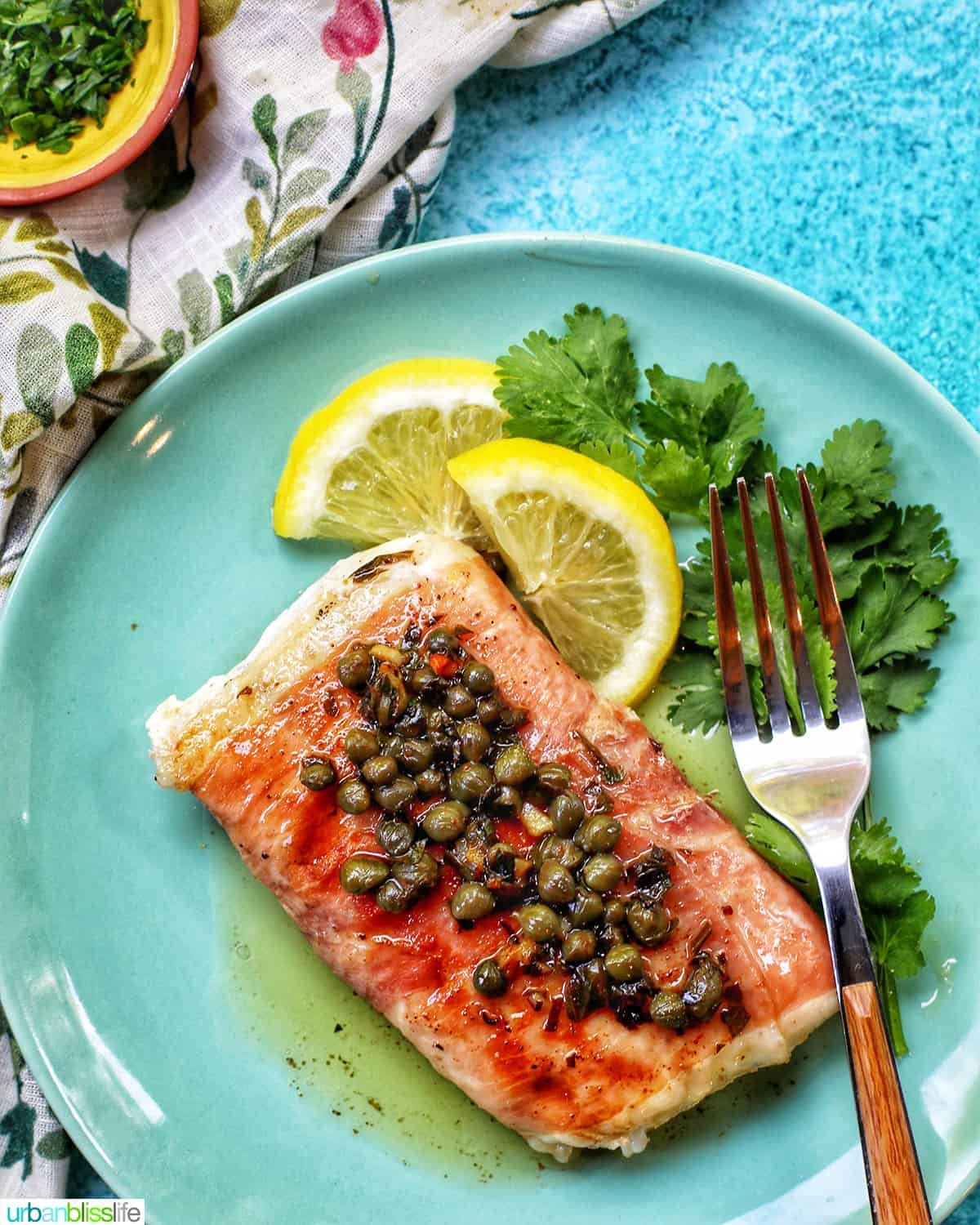 prosciutto wrapped halibut on a green plate