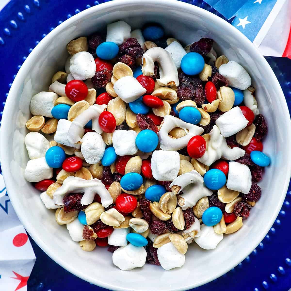 red white and blue trail mix in a bowl.