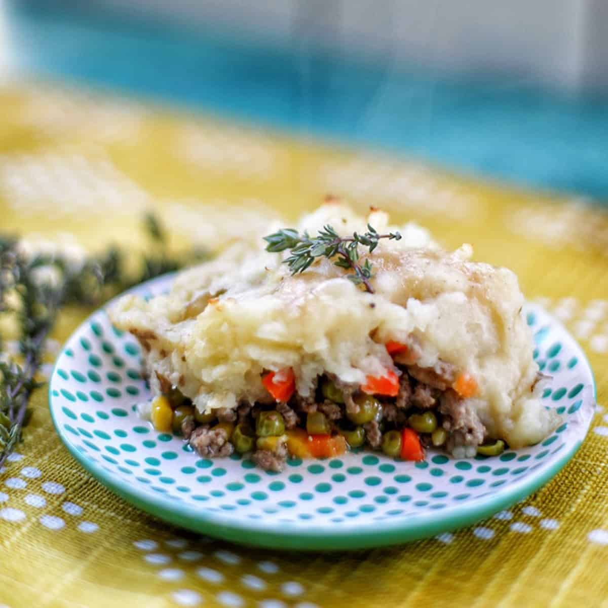 slice of shepherd's pie on a polka dot plate.