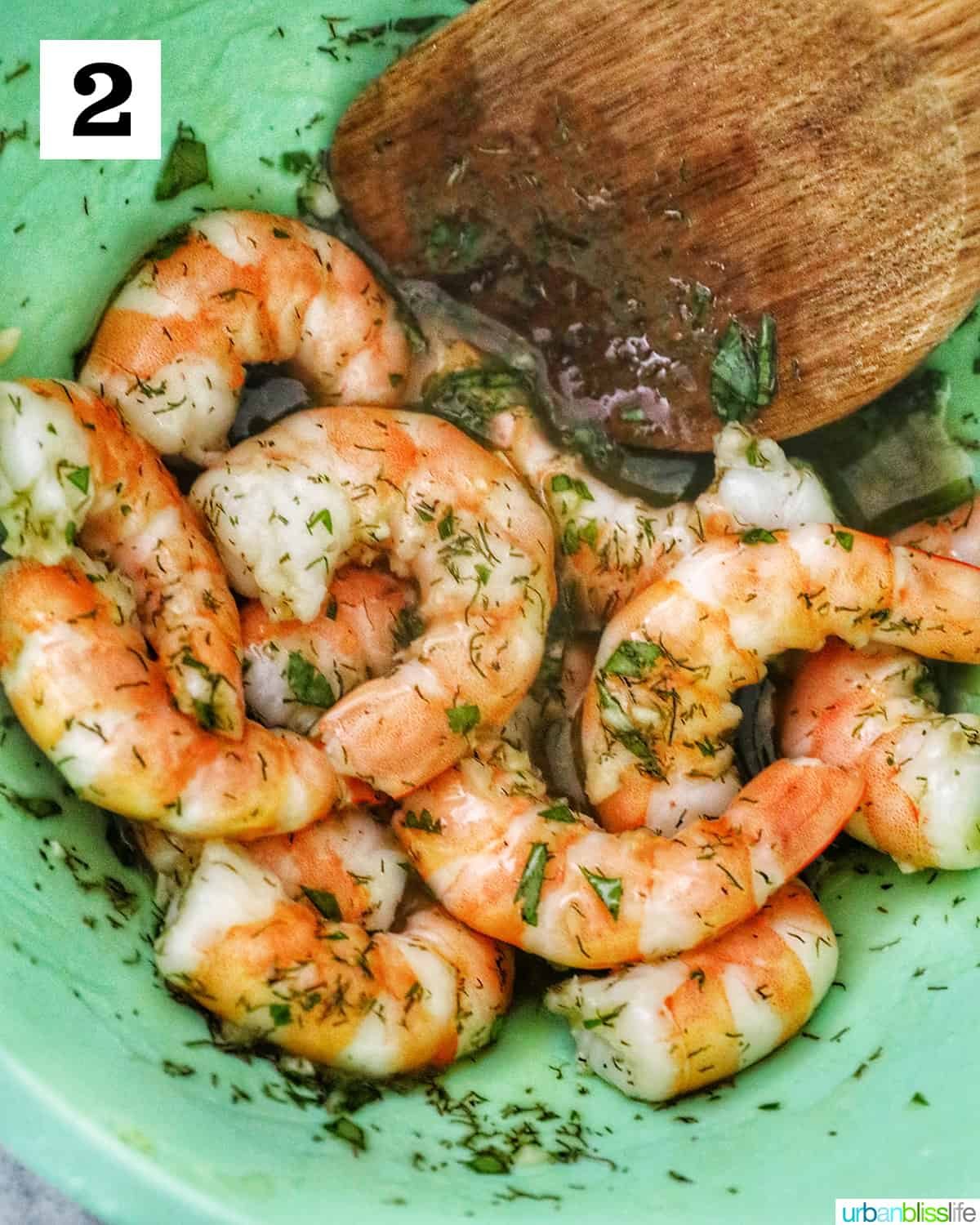 shrimp added to herb oil mixture for prawns canapé.