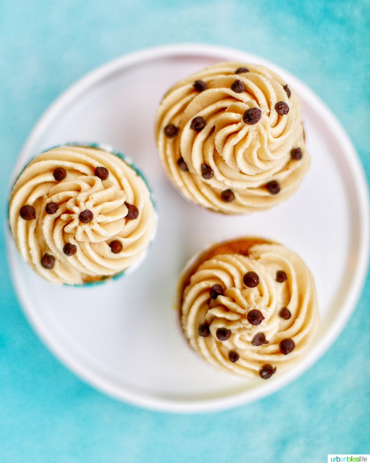 three cupcakes looking down at the cookie dough frosting tops with chocolate chips