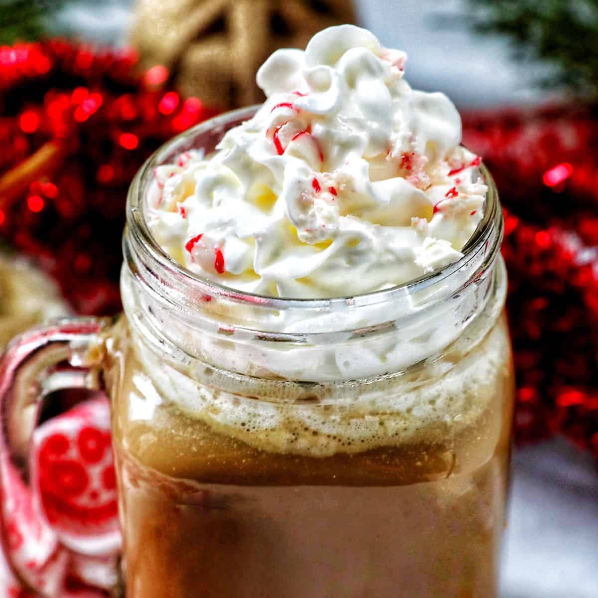 glass mug of white chocolate peppermint mocha with whipped cream.
