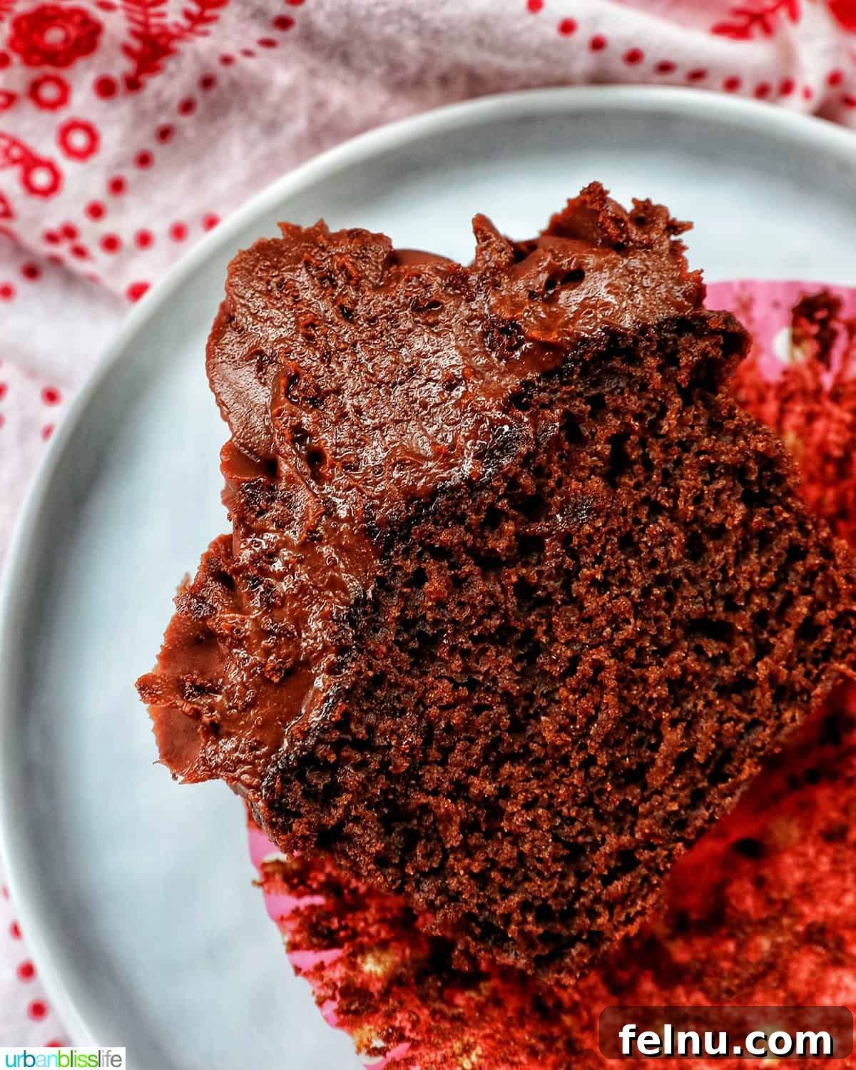 Velvet Chocolate Fudge Cupcakes 19 one chocolate fudge cupcake topped with chocolate ganache frosting cut in half.