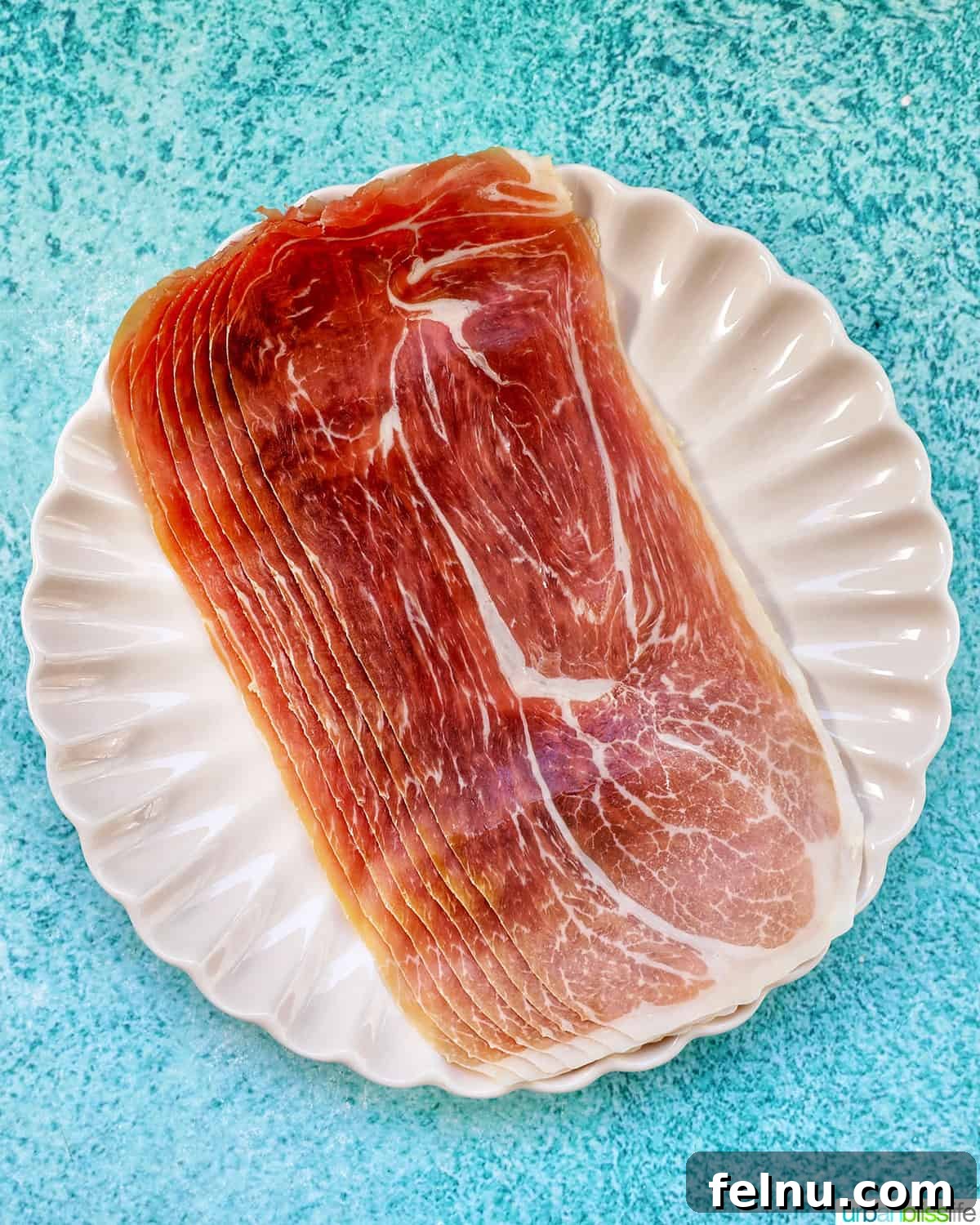 Prosciutto strips arranged on a plate.