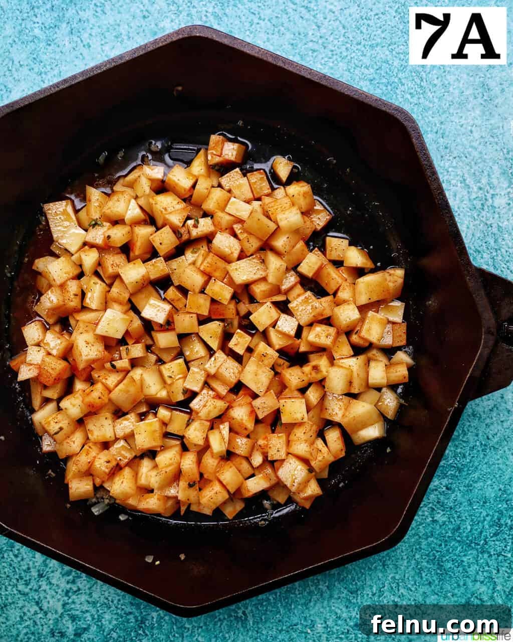 Sizzling Sausage Potato Hash 15 Cooked sausage mixture being transferred to a bowl.