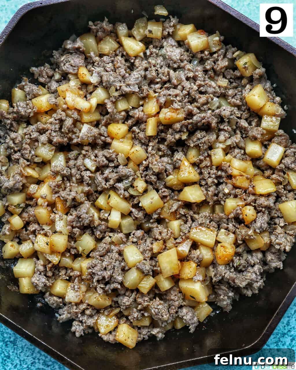 Sizzling Sausage Potato Hash 18 Sausage and potatoes being tossed together in the skillet.