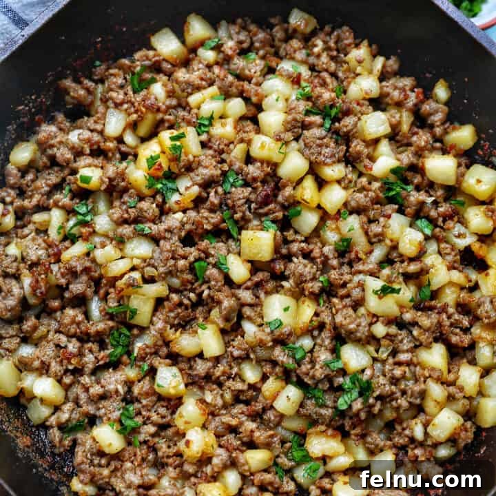 Sizzling Sausage Potato Hash 22 breakfast sausage potato hash in a cast iron skillet.