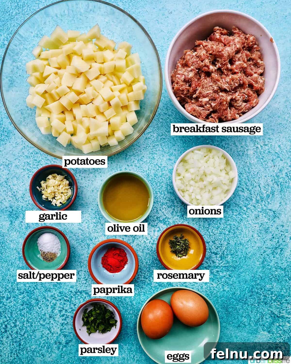 Sizzling Sausage Potato Hash 4 All the fresh ingredients for breakfast sausage potato hash laid out on a cutting board.