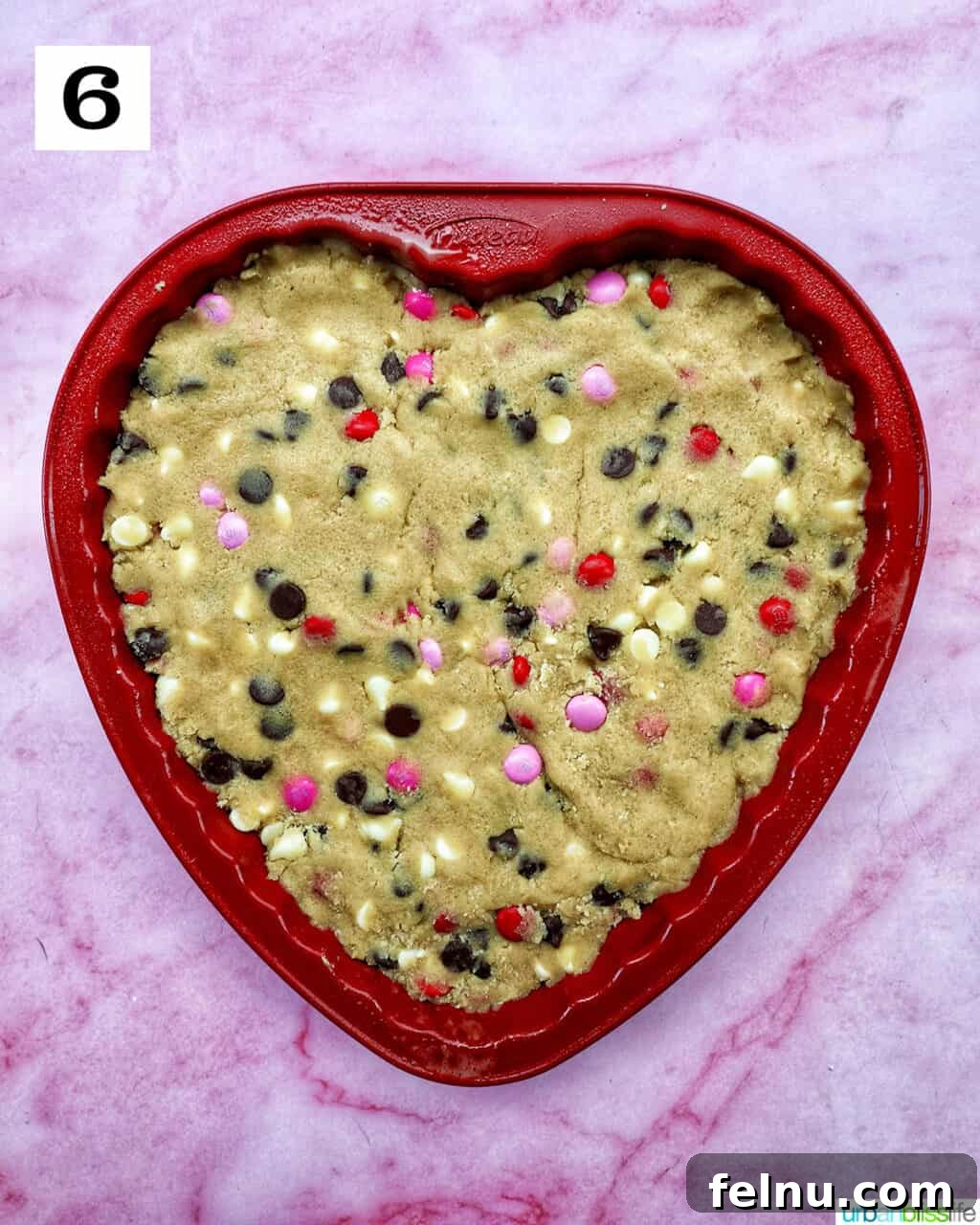 Love Struck Cookie Cake 13 A heart-shaped Valentine's Day cookie cake with red, white, and pink M & M decorations.