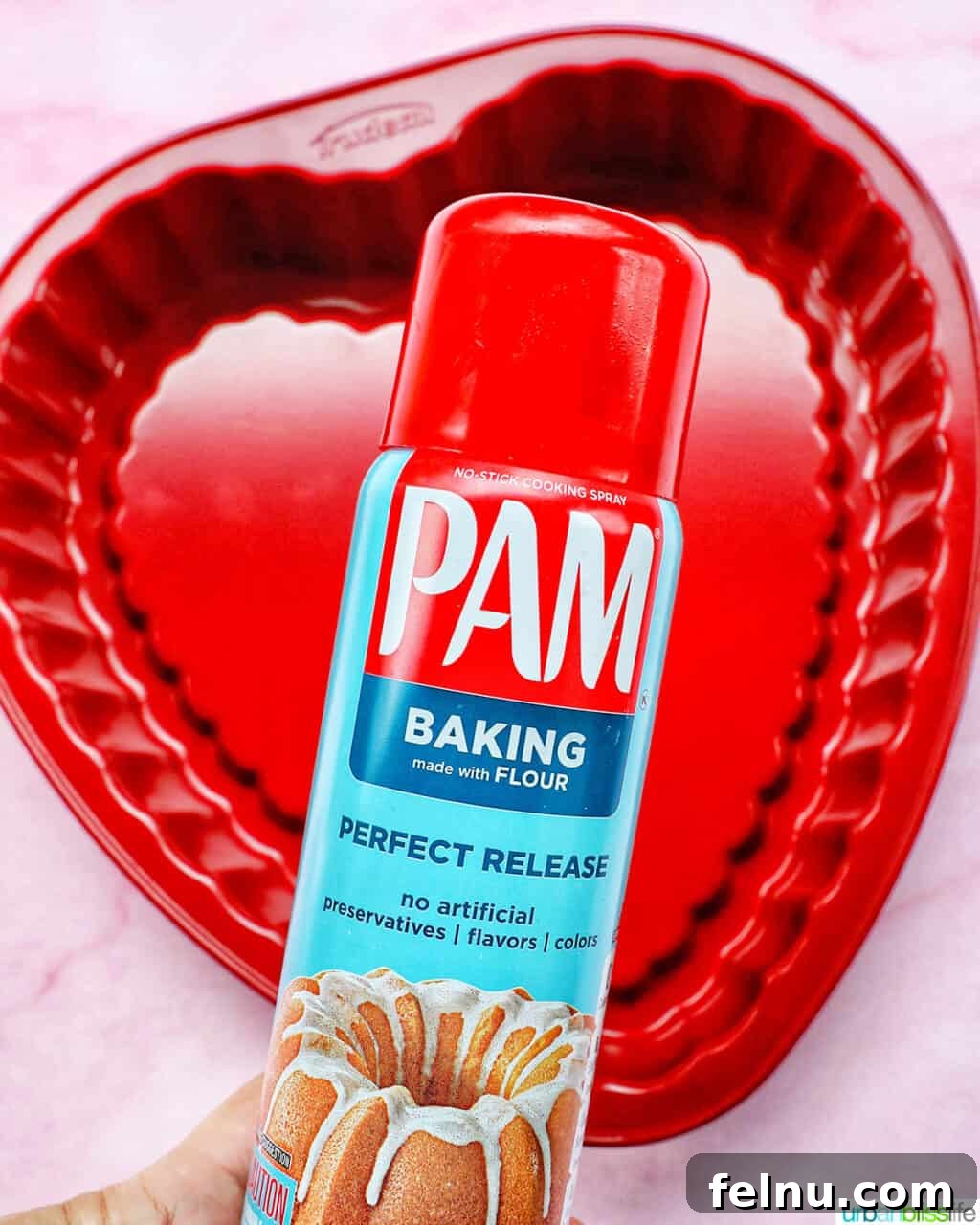 Love Struck Cookie Cake 6 Pam baking spray over a red heart-shaped baking pan.