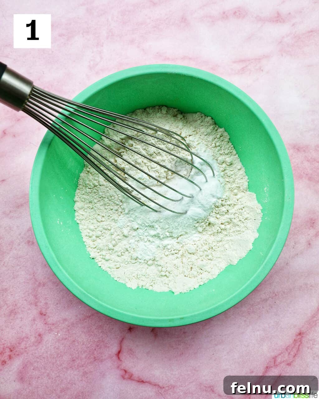 Love Struck Cookie Cake 7 whisk and dry ingredients in a green bowl.