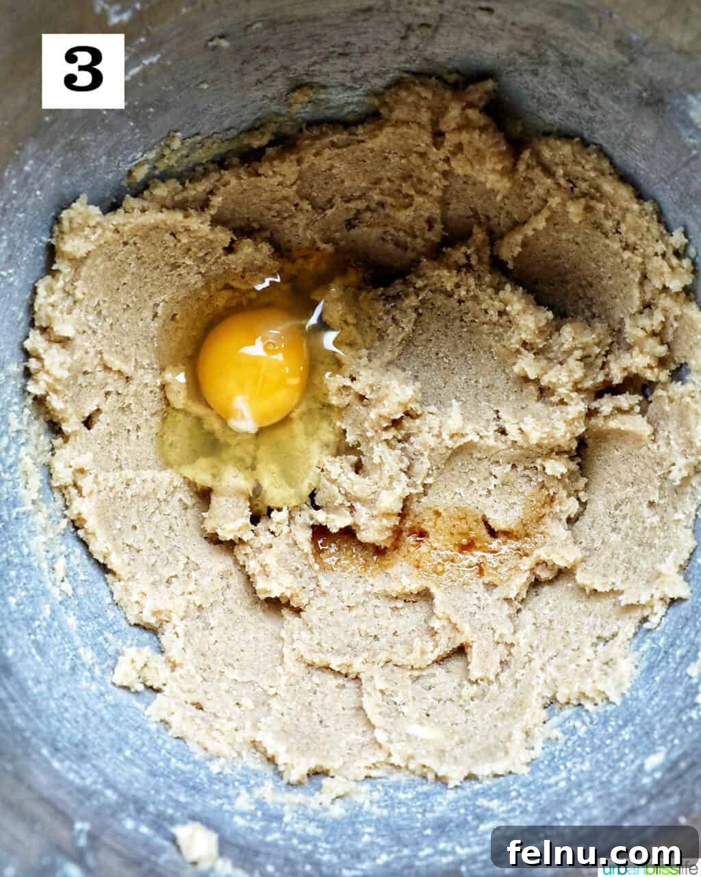 Love Struck Cookie Cake 9 cookie batter with an egg in a stand mixer bowl.