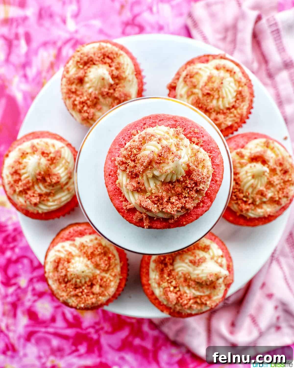 Strawberry Shortcake Crunch Cupcakes 23 Several delightful strawberry crunch cupcakes arranged artfully on stacked cupcake pedestals, captured from an overhead perspective.