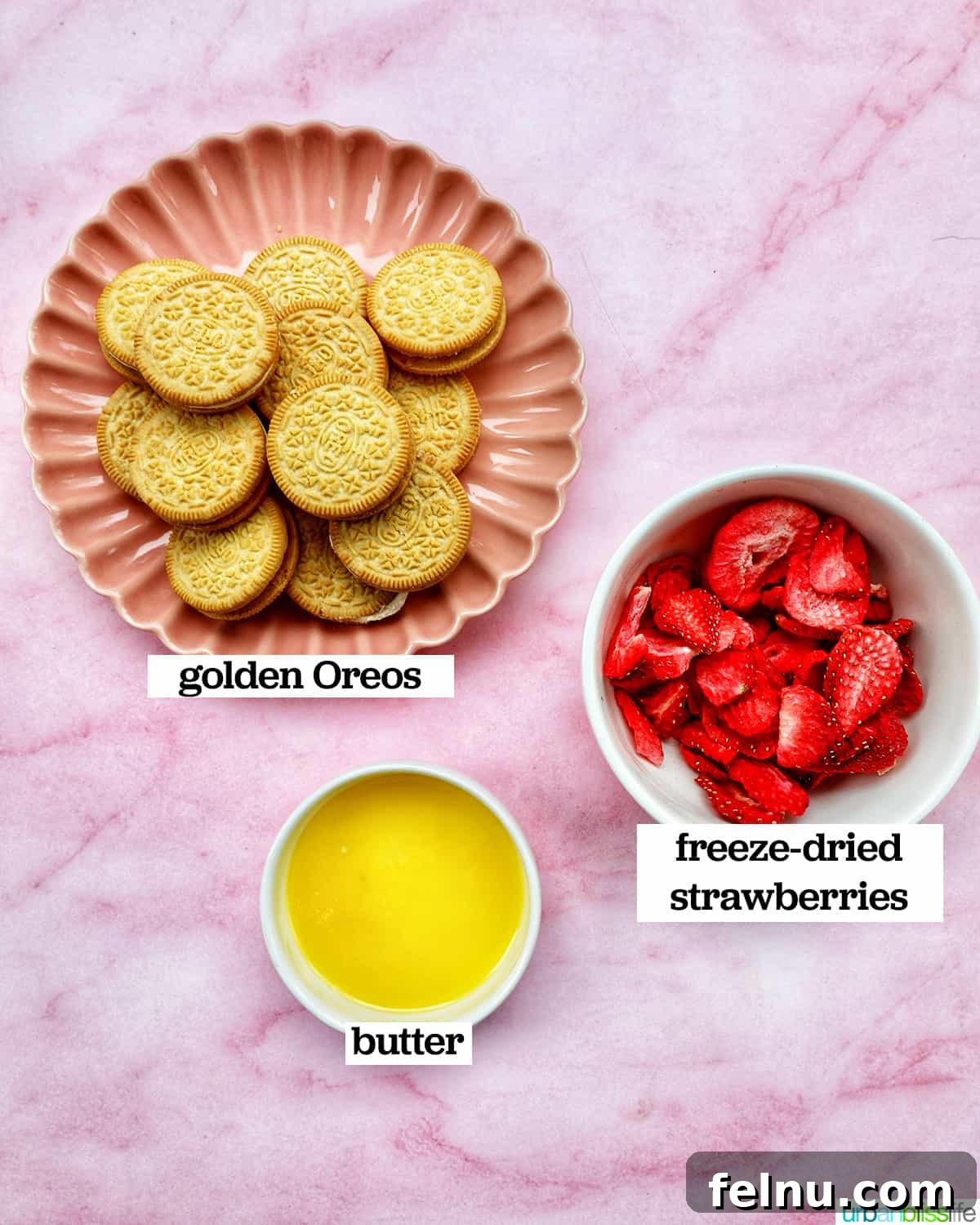 Strawberry Shortcake Crunch Cupcakes 4 Individual bowls showcasing the key ingredients for the strawberry crunch topping: vibrant freeze-dried strawberries, melted golden butter, and classic Golden Oreo cookies.