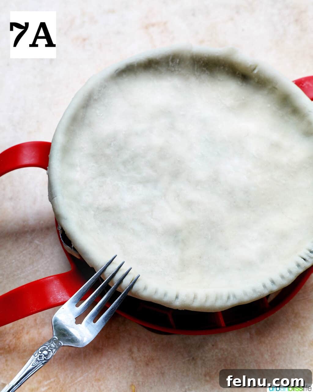 Flaky Air Fryer Chicken Pot Pie 13 fork pressing on the sides of unbaked top crust.