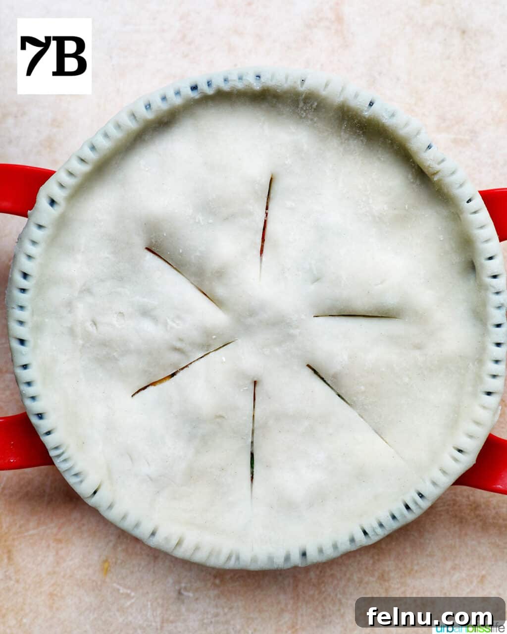 Flaky Air Fryer Chicken Pot Pie 14 unbaked top pie crust with slits cut at the top in a baking pan.