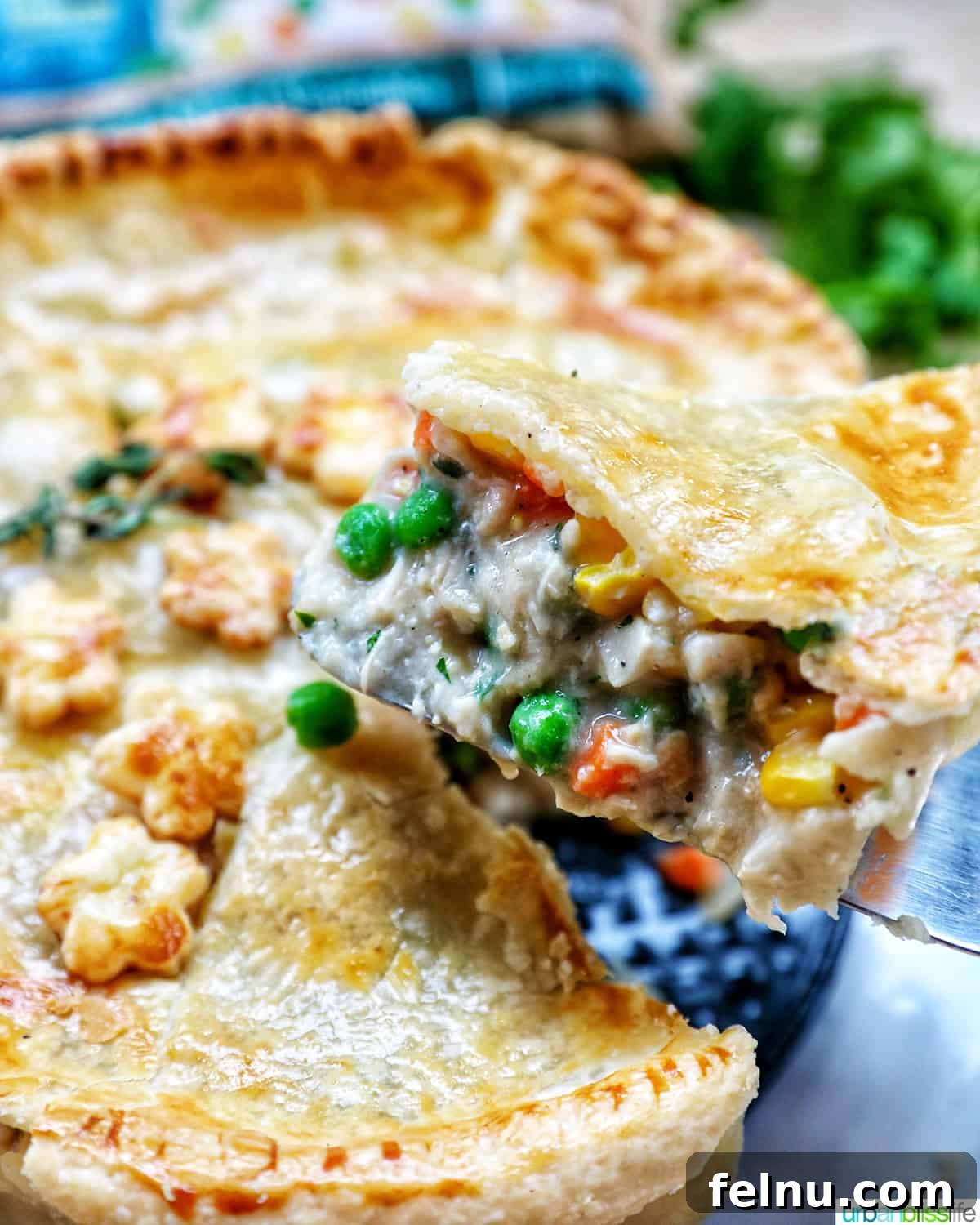 Flaky Air Fryer Chicken Pot Pie 17 slice of chicken pot pie being lifted away from the rest of the chicken pot pie.
