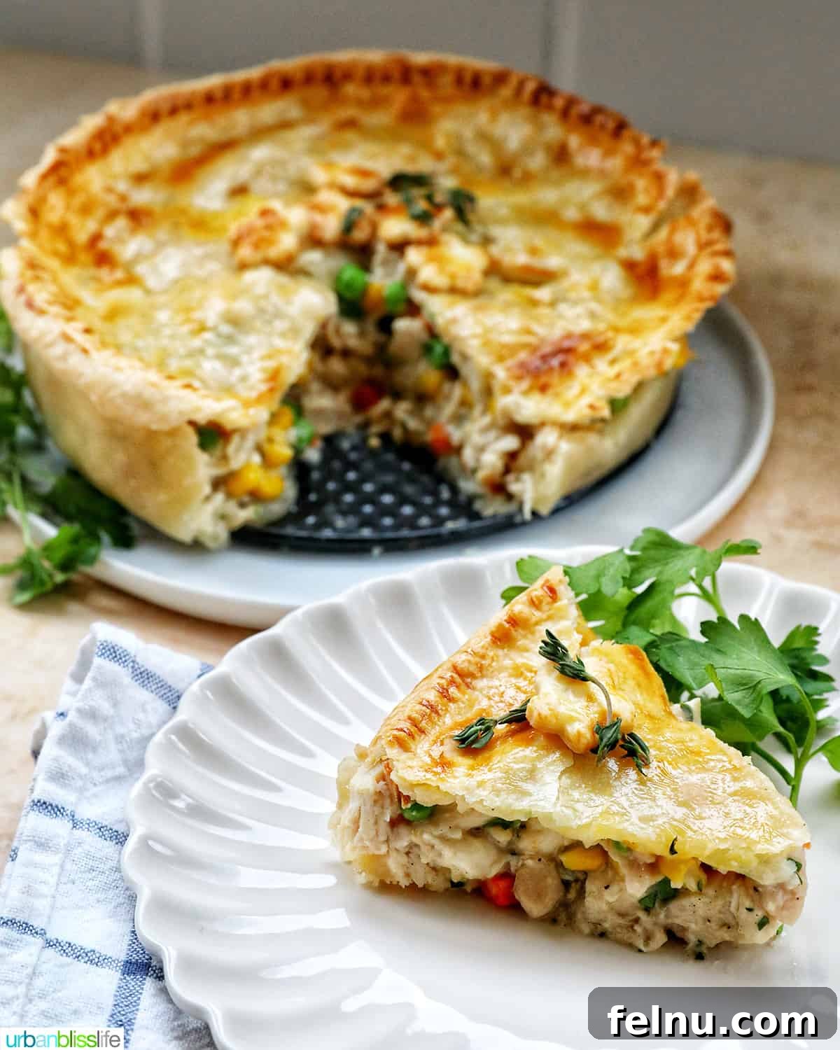 Flaky Air Fryer Chicken Pot Pie 3 slice of air fryer chicken pot pie on a plate with a full chicken pot pie behind it.