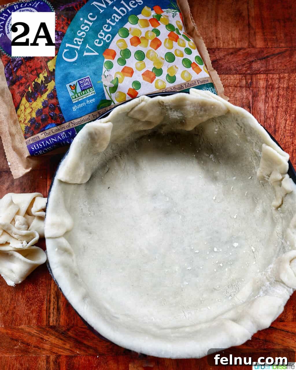 Flaky Air Fryer Chicken Pot Pie 6 pie crust in the bottom of a baking pan.