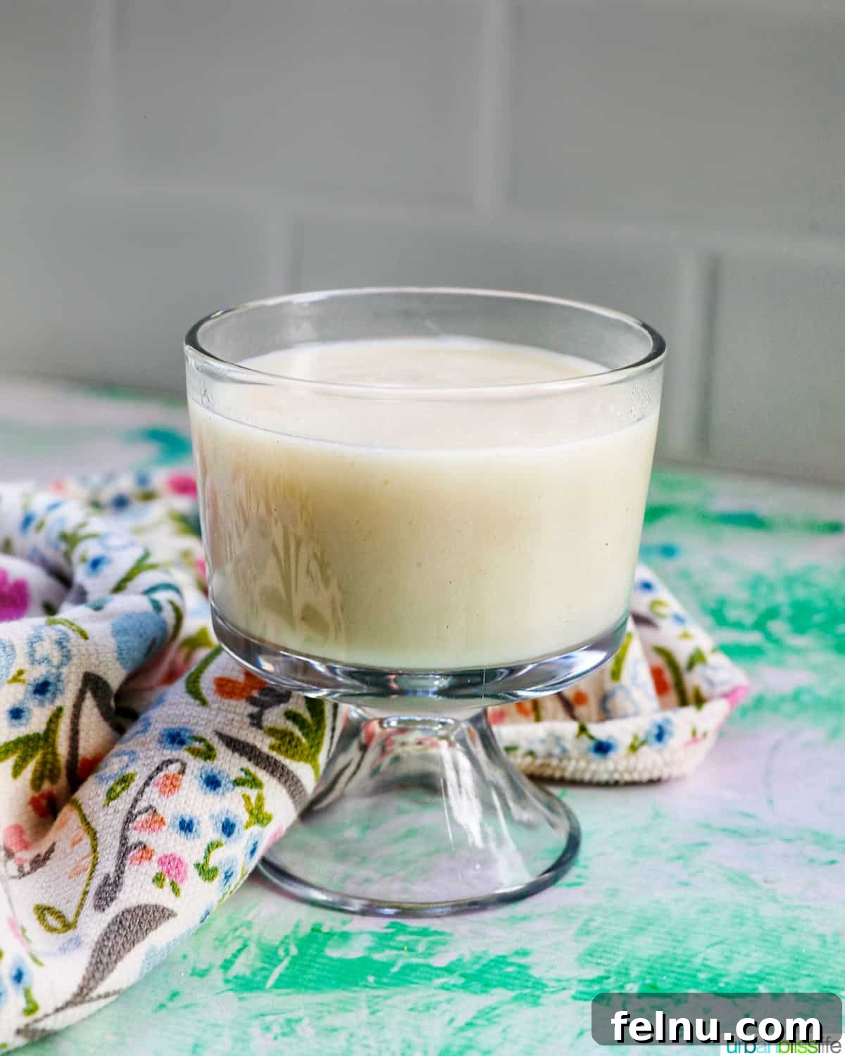 A close-up of a parfait bowl filled with creamy homemade vanilla pudding.