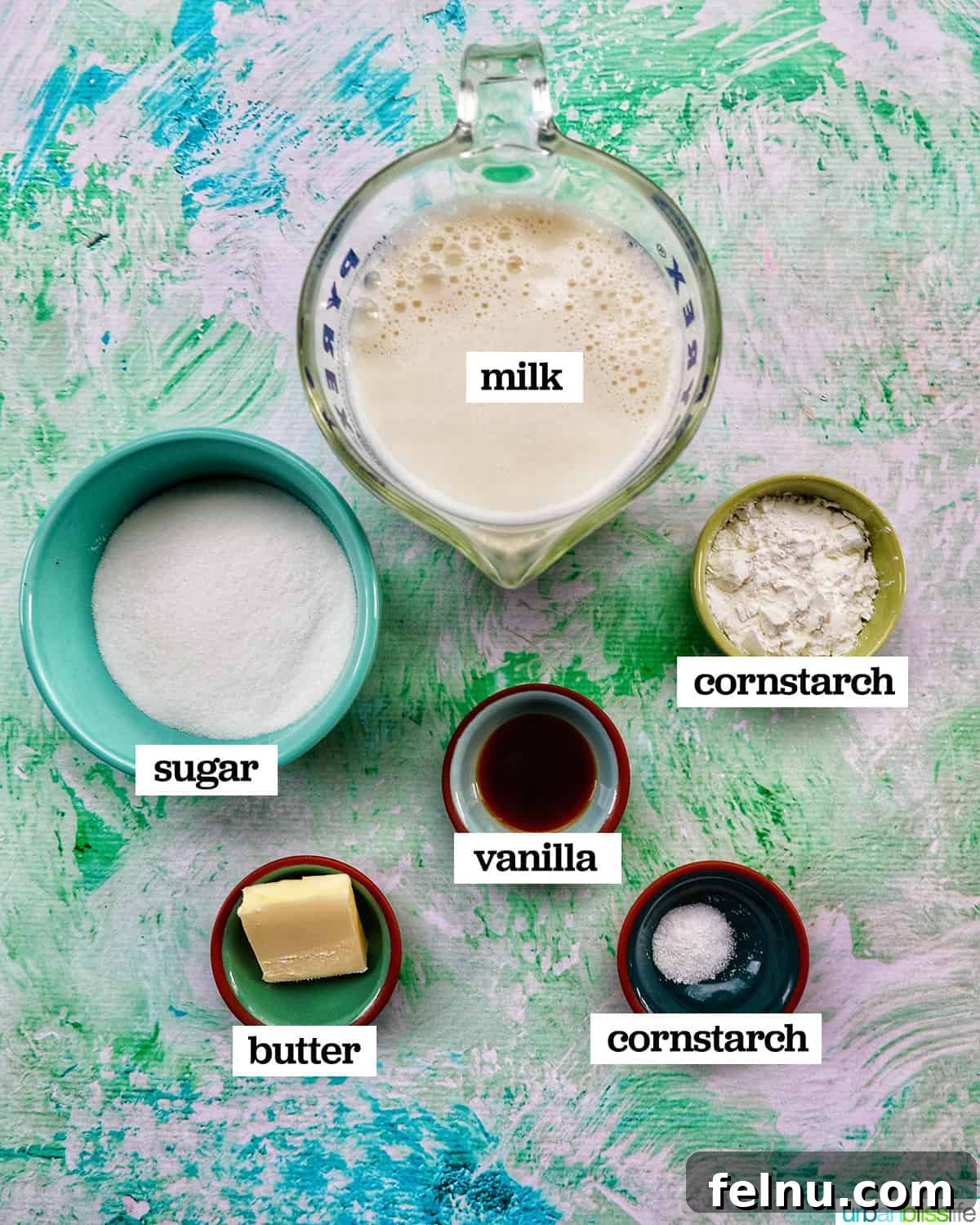 Bowls filled with the essential ingredients needed to make homemade vanilla pudding.