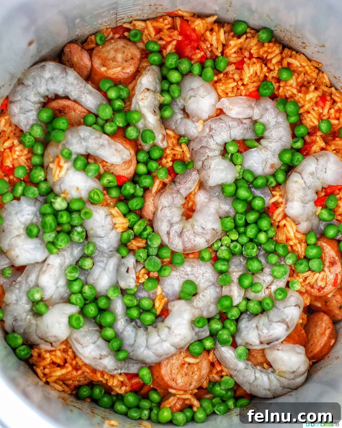 Flavorful Instant Pot Shrimp Meals 4 shrimp, peas, and seasoned rice with sausages to make jambalaya in an Instant Pot.