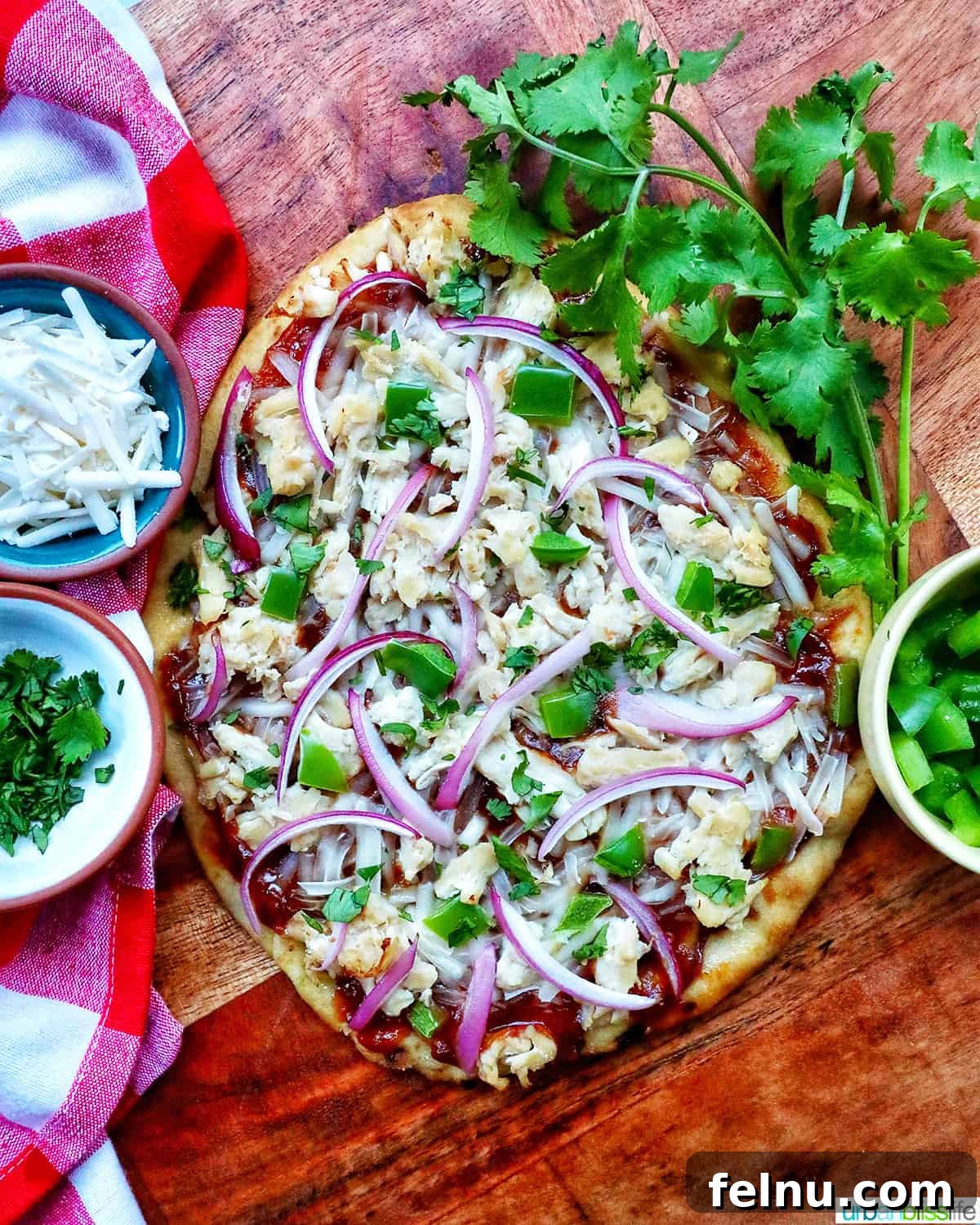 BBQ Chicken Flatbread Feast 11 A whole BBQ chicken flatbread pizza on a wooden board, ready to be sliced and served.