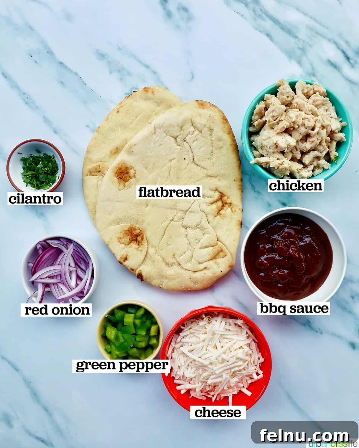 BBQ Chicken Flatbread Feast 4 Ingredients laid out on a marble surface for making BBQ chicken flatbread pizza.