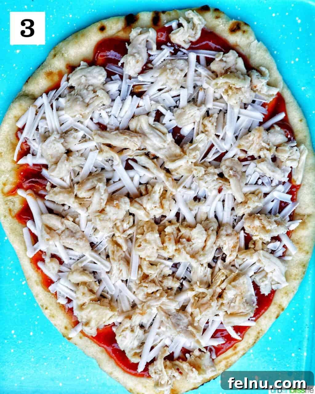 BBQ Chicken Flatbread Feast 7 Adding cooked chicken to the flatbread on top of the cheese.