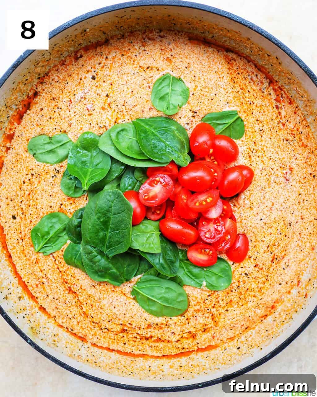 Velvety Tuscan Chicken Pasta 14 Fresh spinach leaves and halved cherry tomatoes added over the sun-dried tomato cream sauce in the large skillet.