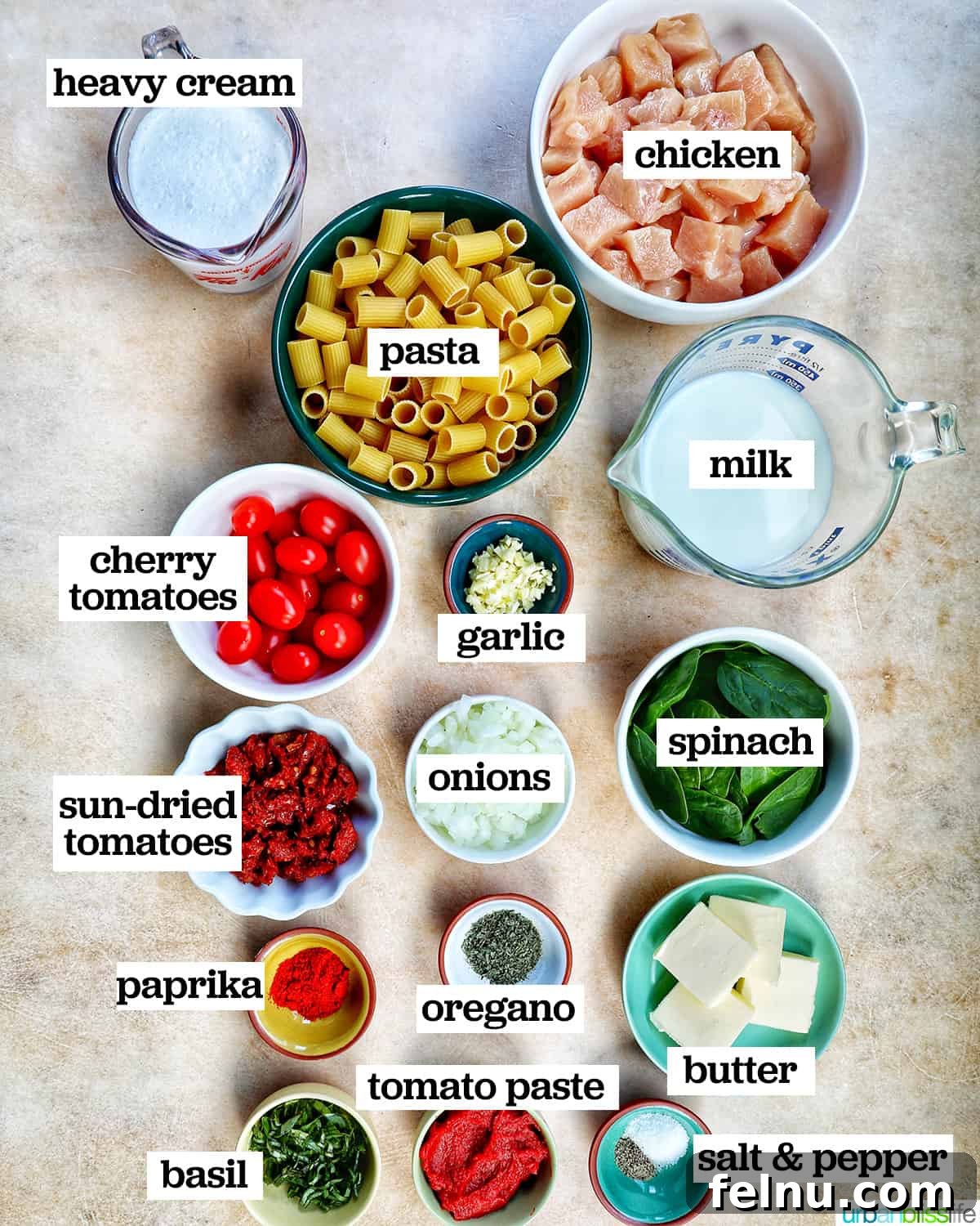 Velvety Tuscan Chicken Pasta 4 Bowls of fresh ingredients including rigatoni, chicken, sun-dried tomatoes, spinach, and herbs, ready for a creamy Tuscan pasta recipe.