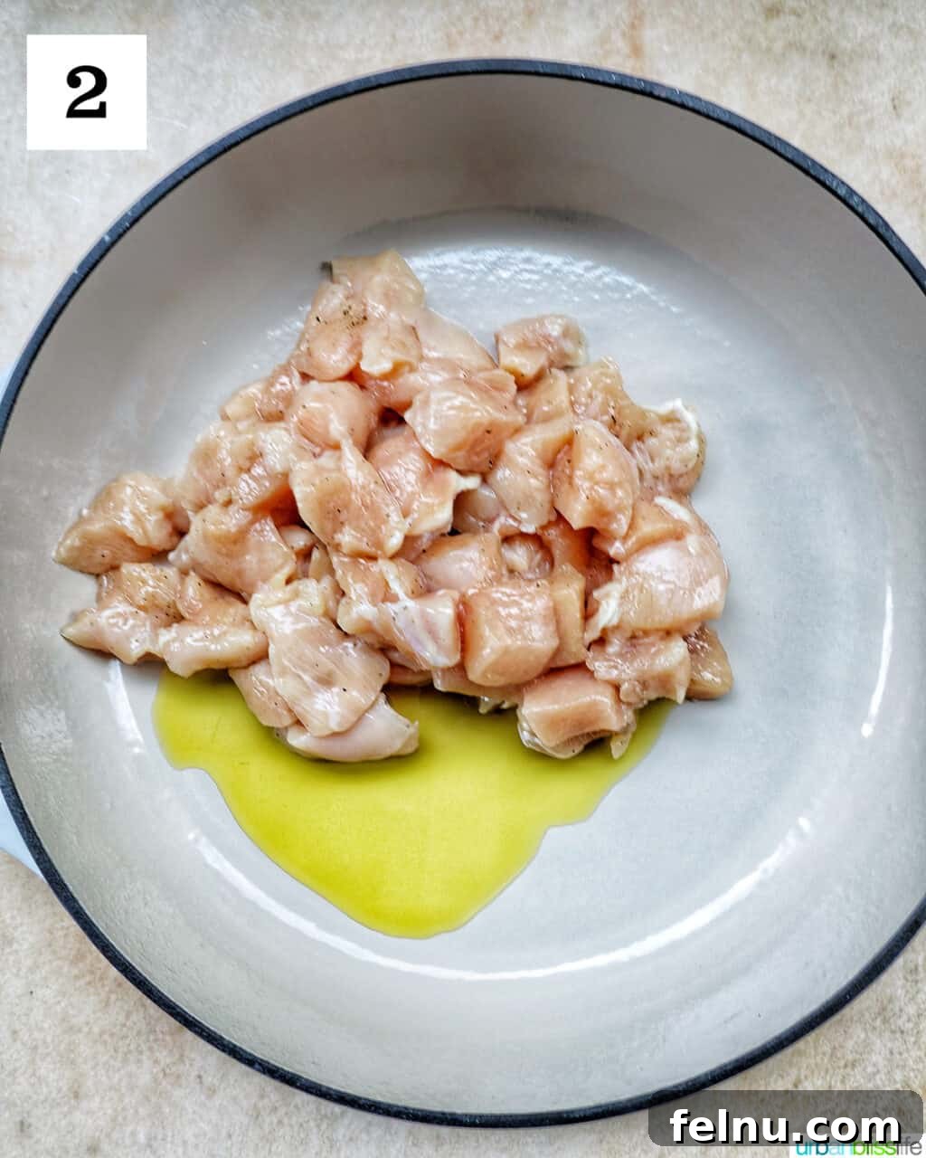 Velvety Tuscan Chicken Pasta 6 Chunks of raw chicken breast searing in olive oil in a large skillet over medium-high heat.