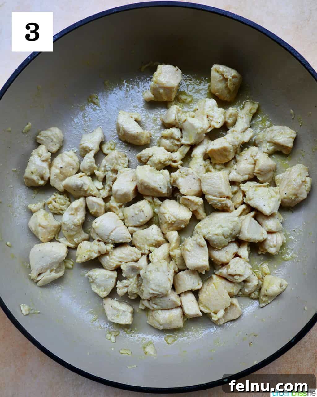 Velvety Tuscan Chicken Pasta 7 Chicken chunks cooking until golden brown and cooked through in a large skillet.