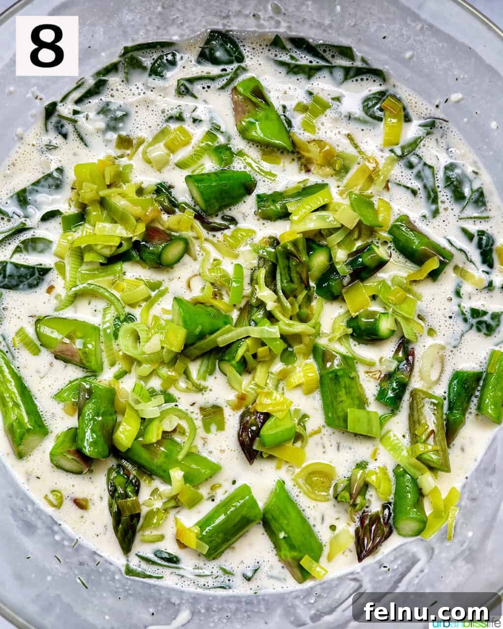 Smoked Salmon & Dill Quiche 15 Sautéed asparagus, leeks, and garlic perfectly mixed into the creamy egg filling in a large bowl, ready for assembly.