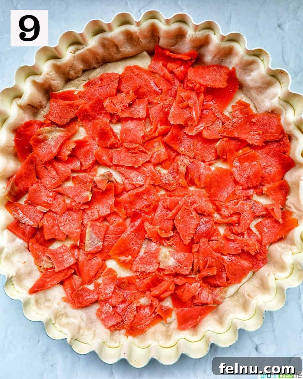 Smoked Salmon & Dill Quiche 16 Small pieces of smoked salmon arranged in an even layer across the bottom of the pre-baked pie crust in the pie plate.