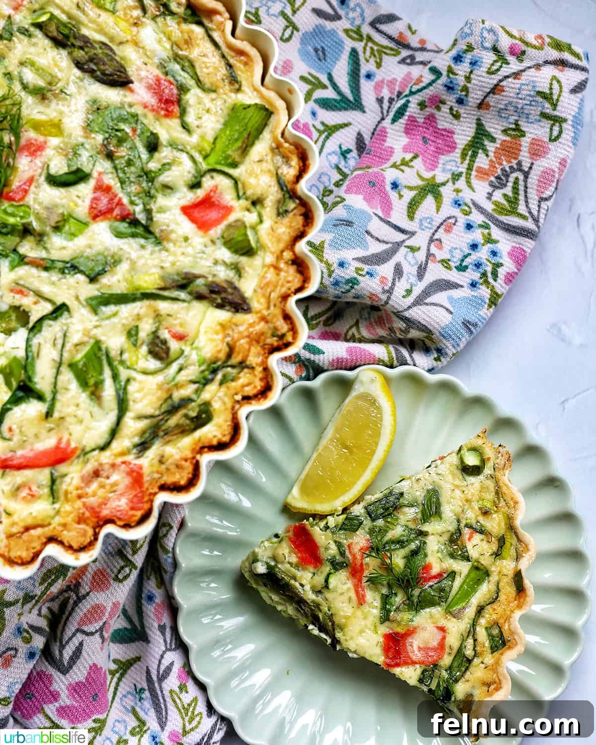Smoked Salmon & Dill Quiche 4 A half-eaten Salmon Quiche on a pedestal next to a perfectly portioned slice on a plate, surrounded by a floral napkin, highlighting its aesthetic appeal.