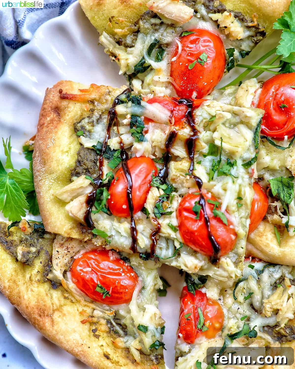 slices of chicken pesto flatbread on a plate, with a delicate balsamic drizzle.