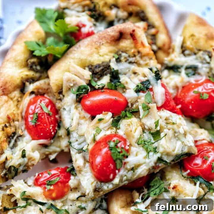 slices of chicken pesto flatbread on a plate.